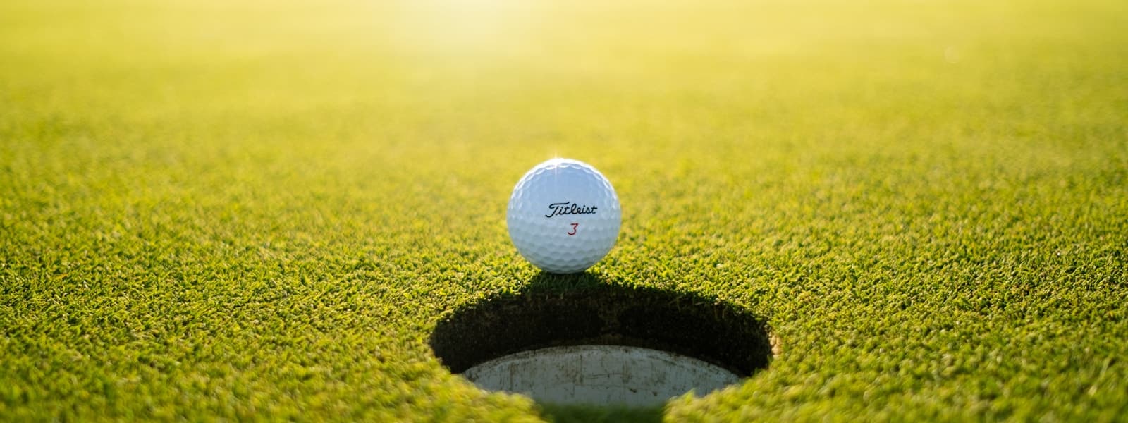 Panoramic view of a golf course at golden hour